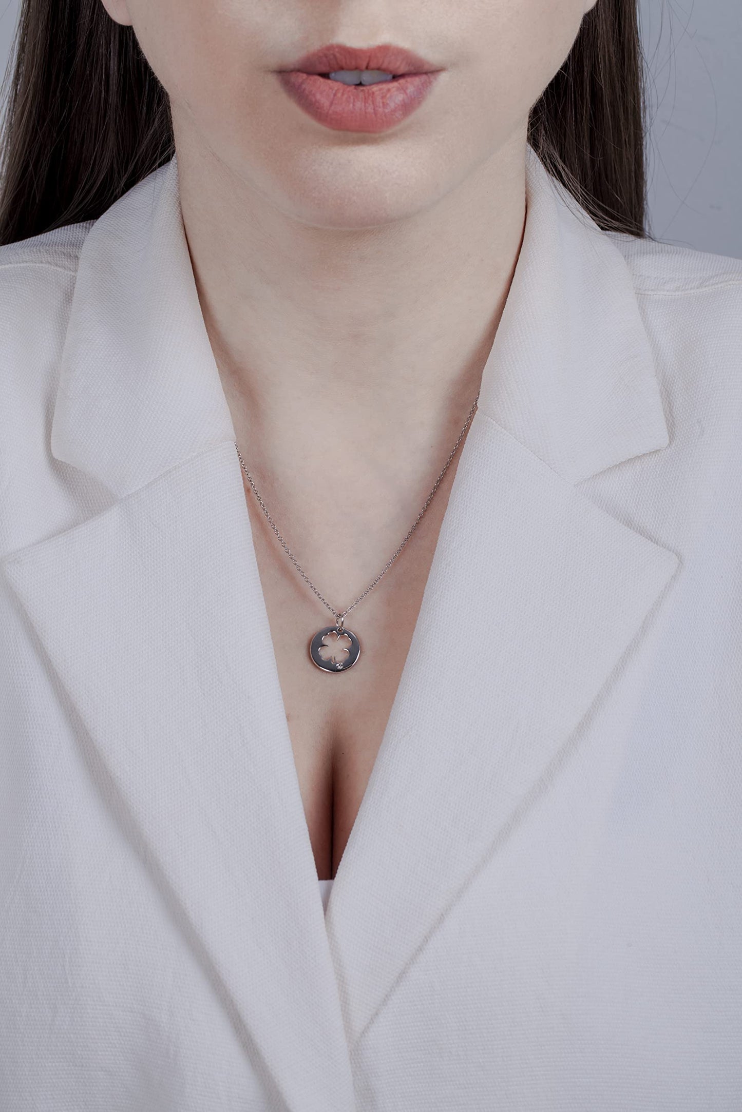Picture of model wearing a clover outline pendant with Canadian diamond.