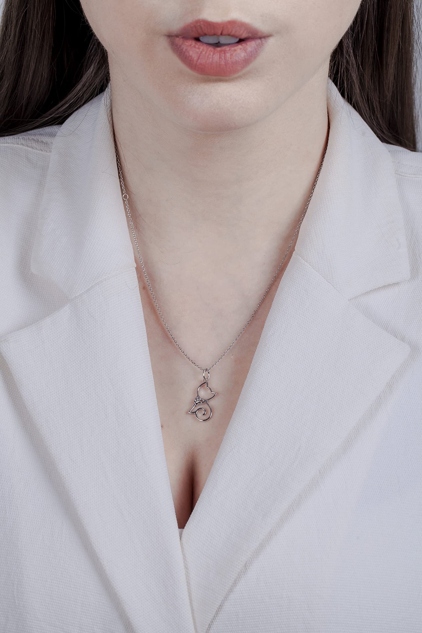 Model wearing Sterling silver cat pendant featuring a round brilliant cut, canadian diamond in the center.