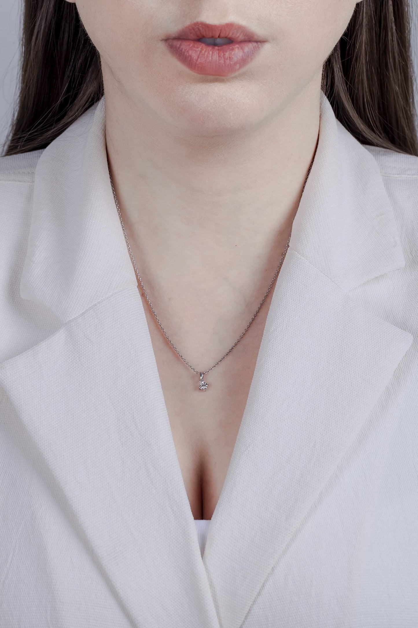 Model wearing Sterling silver solitaire pendant featuring a round brilliant cut, canadian diamond in a miracle setting.