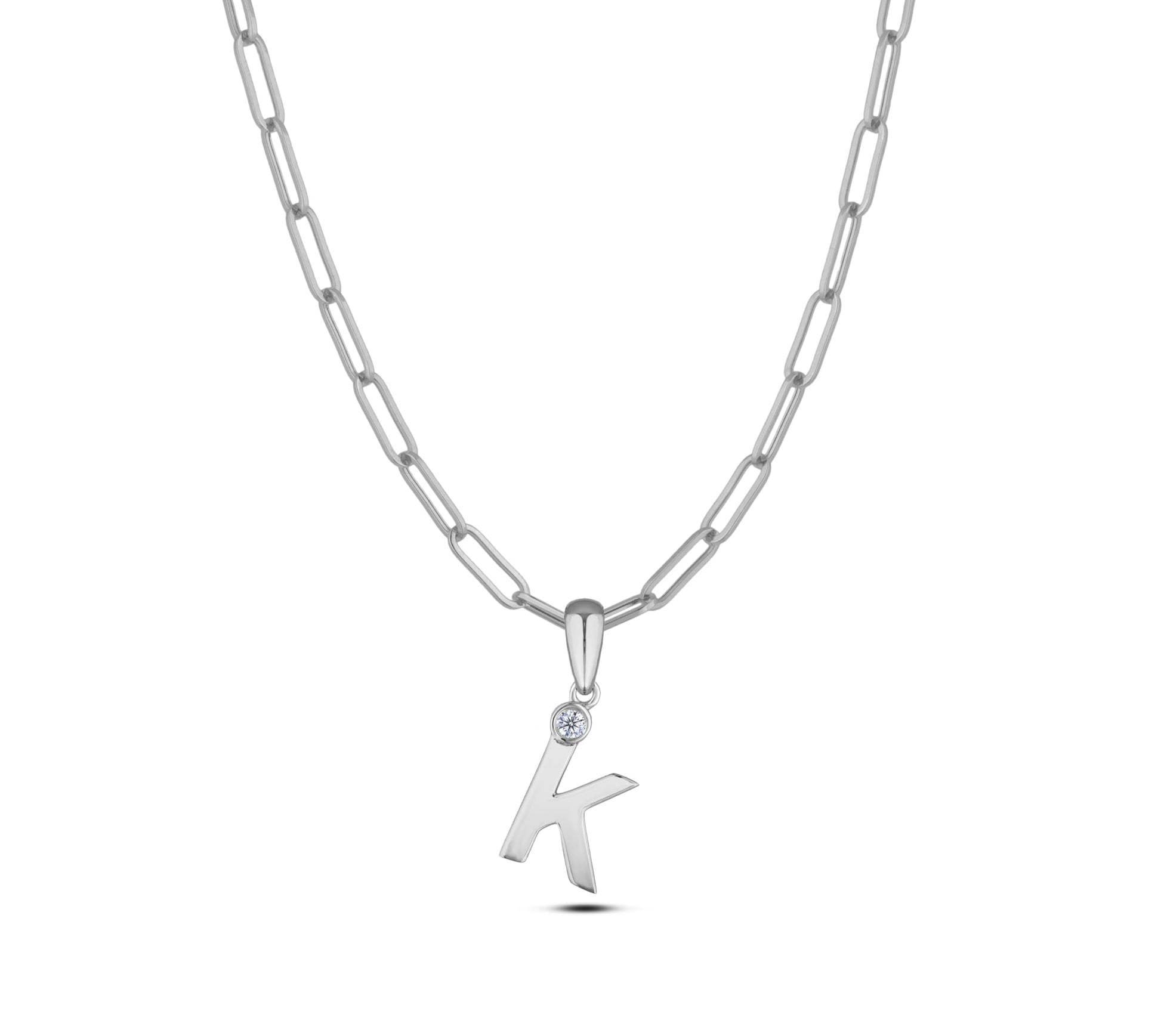 Sterling silver Canadian diamond pendant necklace featuring a black style letter K design, displayed on a matching silver paperclip chain.
