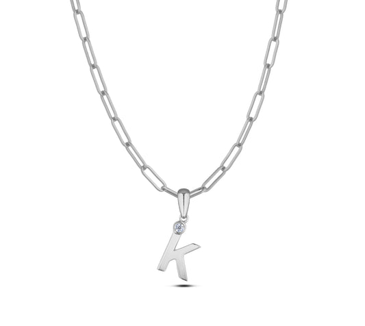 Sterling silver Canadian diamond pendant necklace featuring a black style letter K design, displayed on a matching silver paperclip chain.
