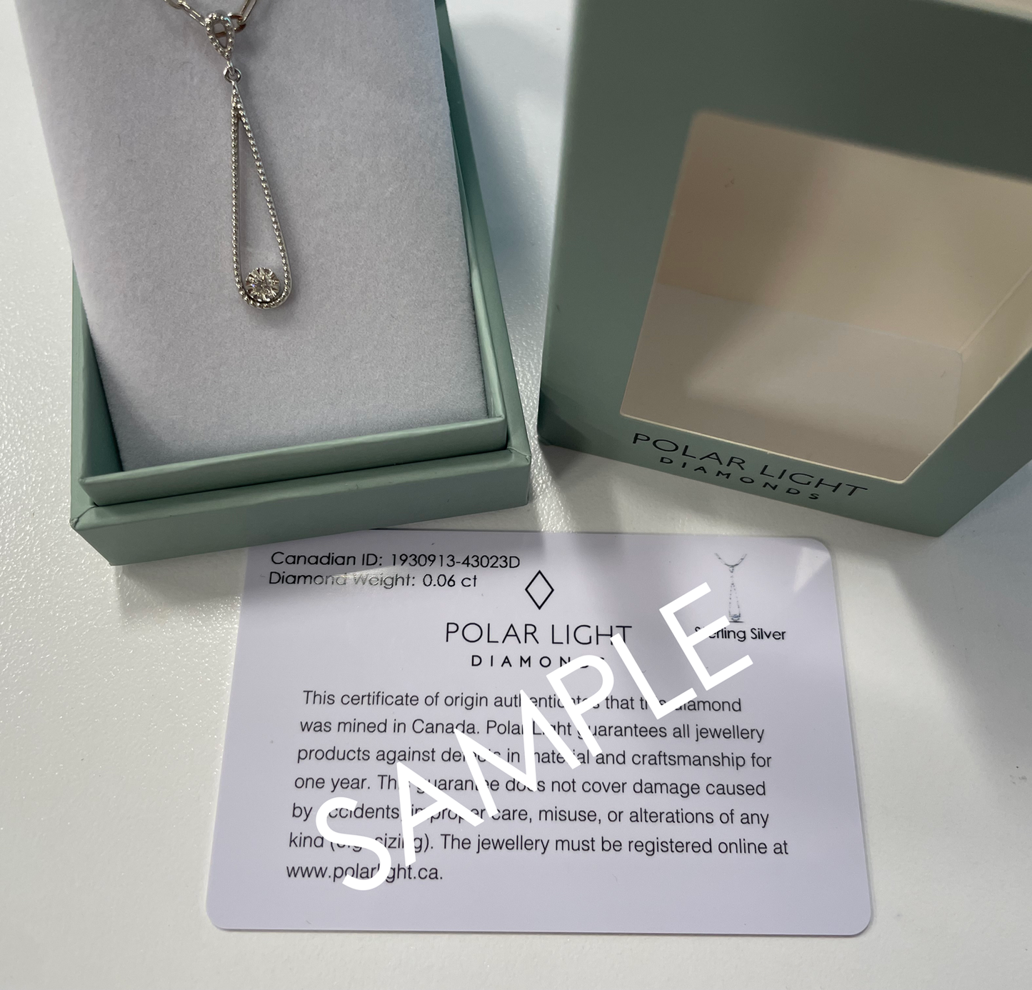 925 Sterling Silver 0.13 Cttw Canadian Diamond Infinity Pendant with Center Dancing Diamond with Paperclip Chain in Polar Light Diamonds packaging and Canadian Diamond ID Certificate