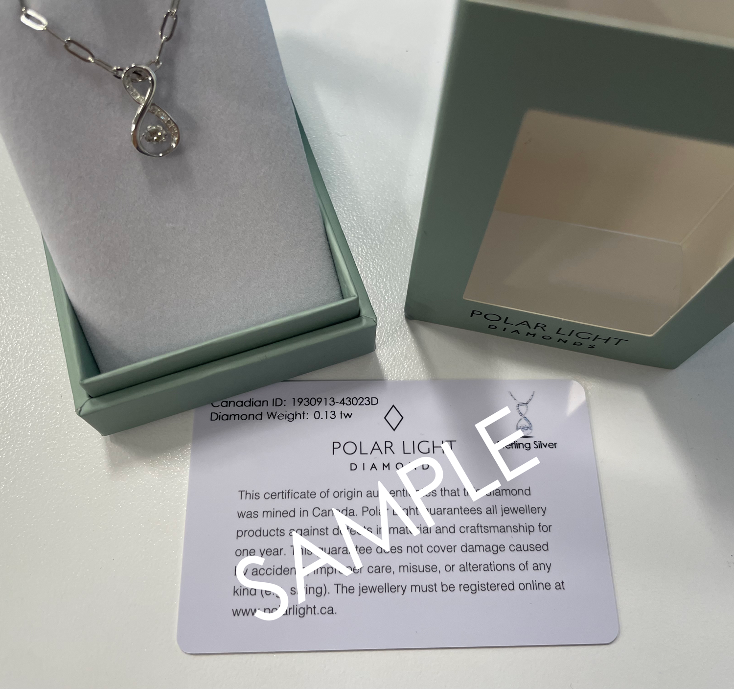 925 Sterling Silver 0.13 Cttw Canadian Diamond Infinity Pendant with Center Dancing Diamond with Paperclip Chain in Polar Light Diamonds box and sample Canadian DIamond ID Certificate