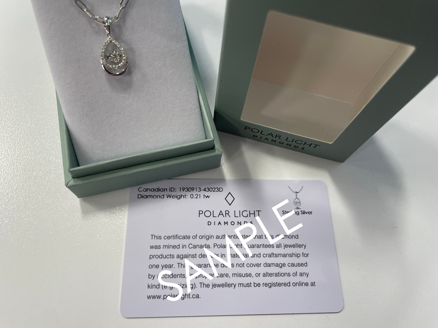 925 Sterling Silver 0.21 Cttw Canadian Diamond Droplet Pendant and Paperclip Chain with Center Dancing Diamond in a  Polar Light Diamonds box with a sample Canadian Diamond ID Cert