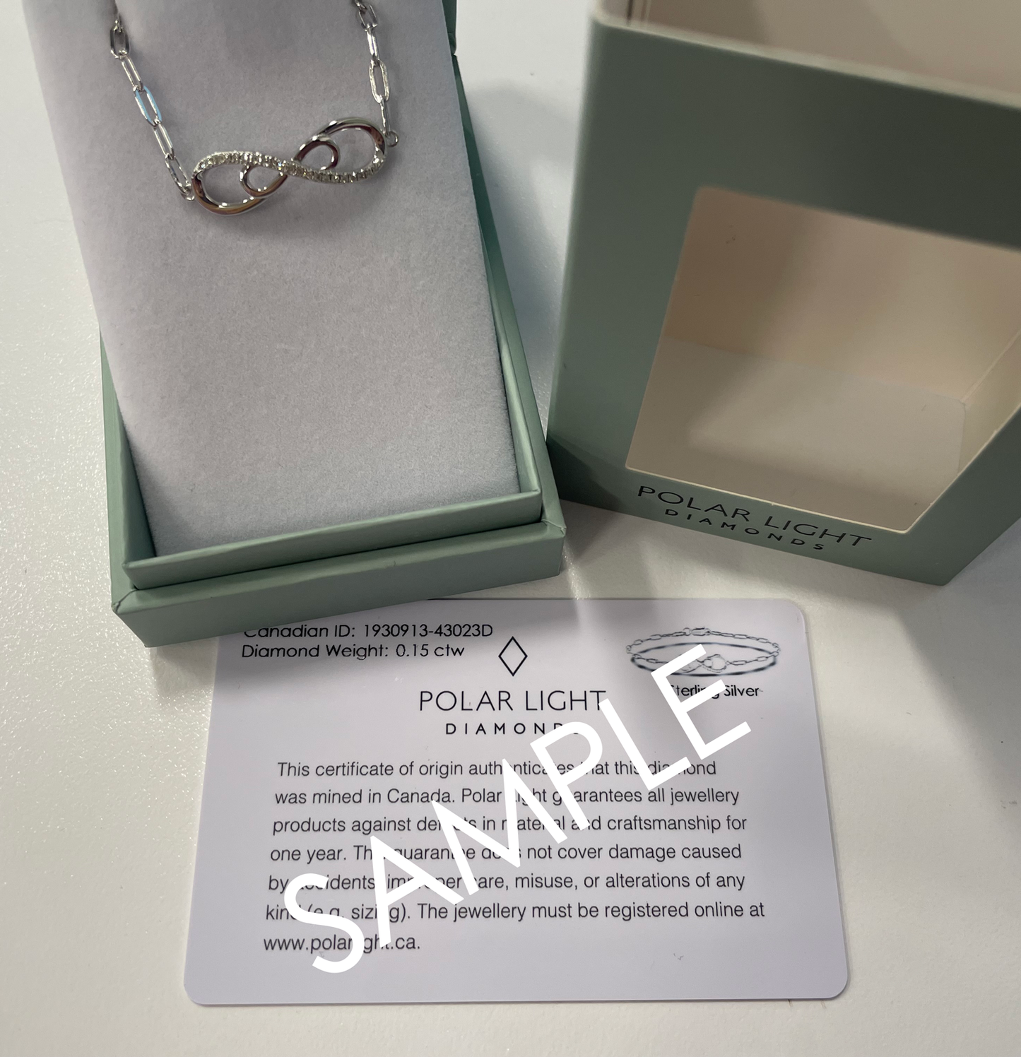 Packaging box and cert sample of 925 Sterling Silver 0.15 Ctw Natural Canadian Diamond and Infinity Symbol Chain Paperclip Bracelet