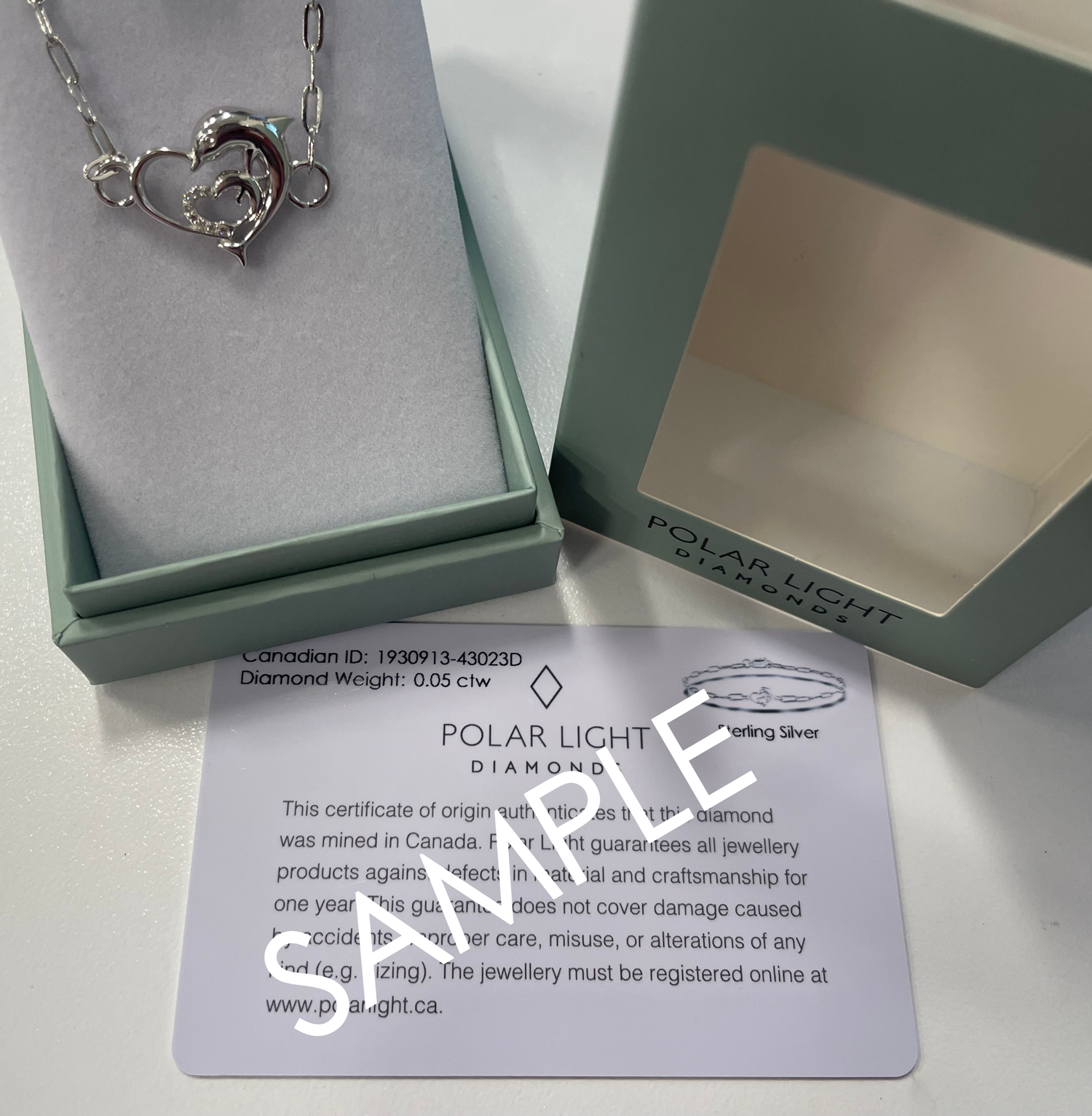 Sample of 925 Sterling Silver Natural Canadian Diamond Dolphin Heart Paperclip Bracelet in a Polar Light Diamond box, accompanied by a Canadian ID certificate.
