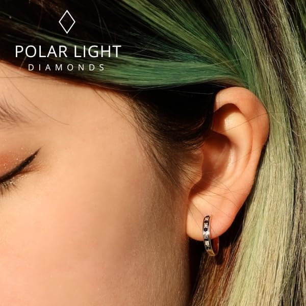 close-up of a model wearing 10K yellow gold channel-set hoop earrings. The design features alternating natural blue sapphires and sparkling Canadian diamonds for a timeless look. The 'Polar Light Diamonds' brand logo is visible, showcasing premium craftsmanship and Canadian heritage.