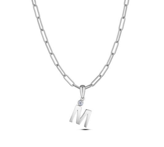 Sterling silver Canadian diamond pendant necklace featuring a black style letter M design, displayed on a matching silver paperclip chain.
