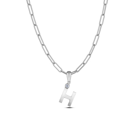Sterling silver Canadian diamond pendant necklace featuring a black style letter H design, displayed on a matching silver paperclip chain.

