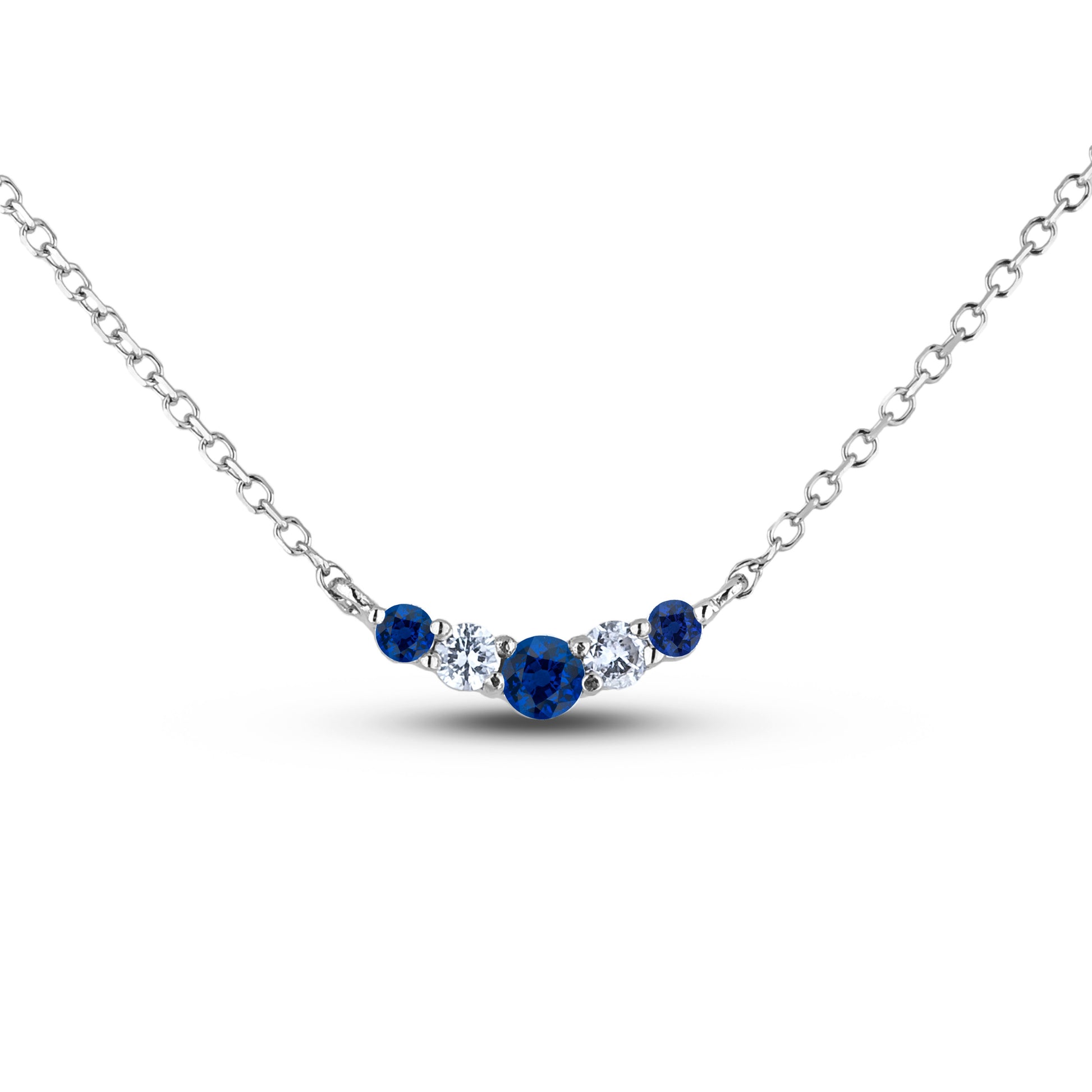 A 925 sterling silver wave pendant featuring three round blue sapphires and two Canadian diamonds set in an alternating pattern. The pendant is shown hanging from a silver chain against a clean white background.