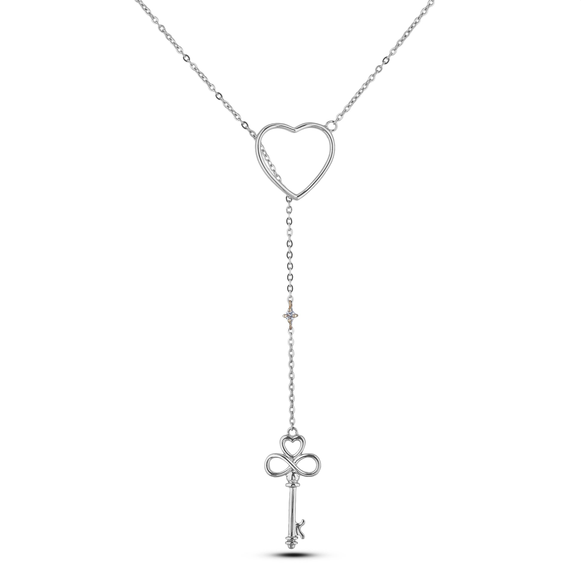 A 925 sterling silver Y-style/Lariat drop necklace on a white background. The chain passes through a polished open-heart slider, dropping down to a dainty Canadian diamond accent in a 10K yellow gold setting, and ending with an intricate key pendant featuring a heart bow and infinity symbol stem.