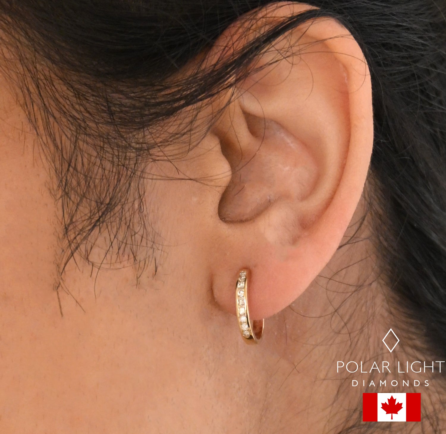 10K Yellow Gold hoop Canadian diamond earring worn by modelwith 'Polar Light Diamonds' logo.