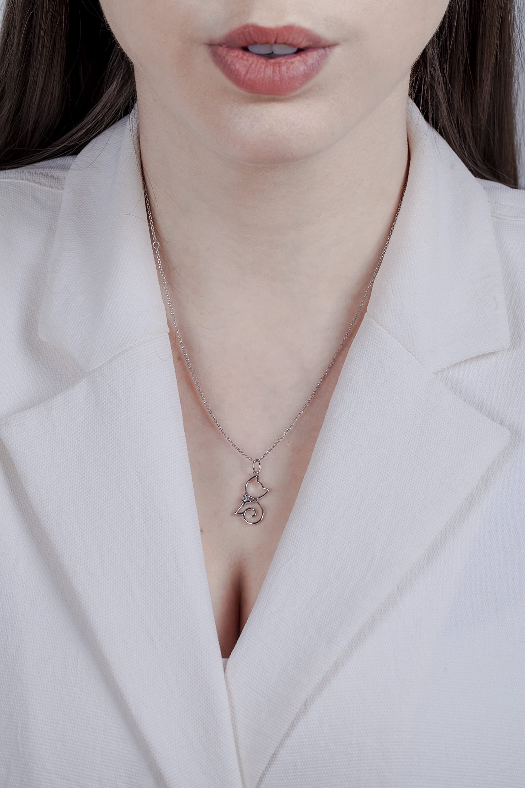 Model wearing Sterling silver cat pendant featuring a round brilliant cut, canadian diamond in the center.