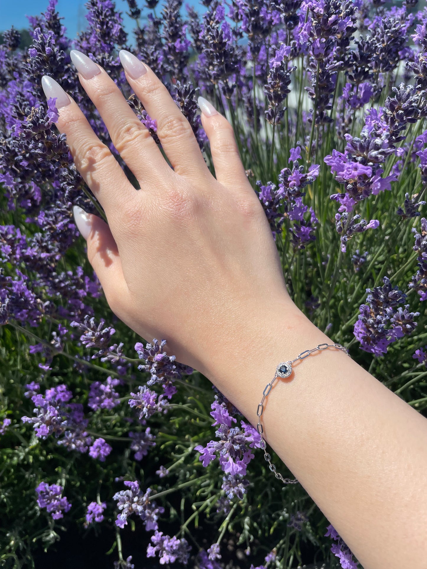 model wearing 925 Sterling Silver Sapphire and Canadian Diamond Halo Paperclip Bracelet
