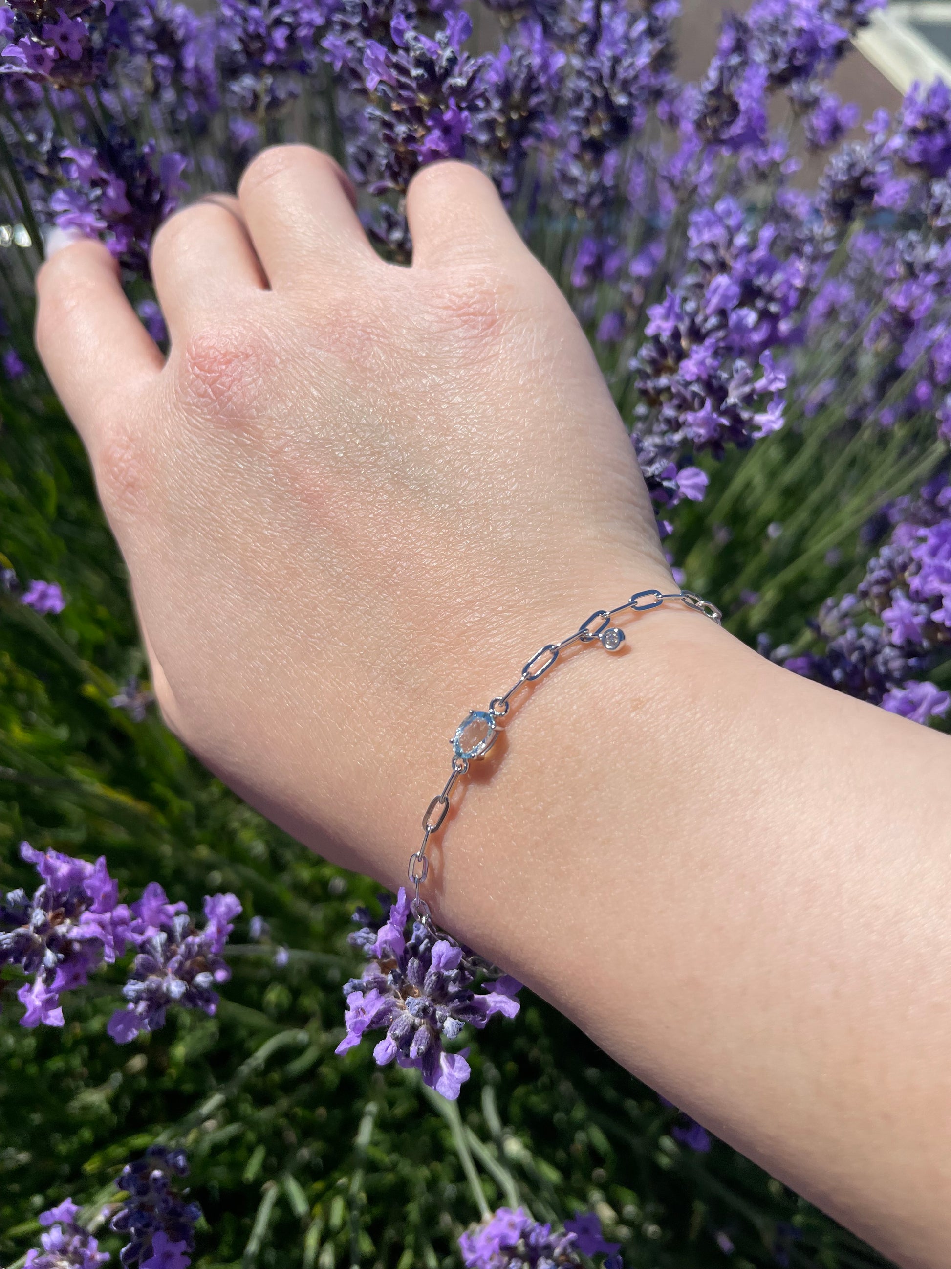 close up of model wearing 925 Sterling Silver 6x4MM Natural Aquamarine and Canadian Diamond Paperclip Bracelet 