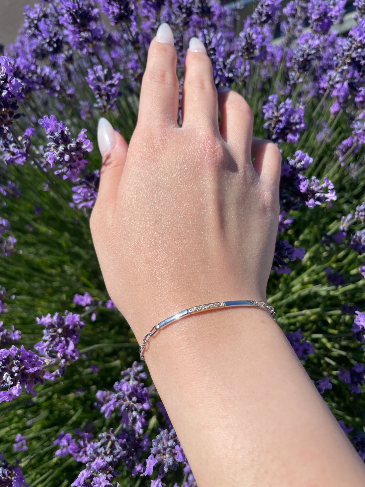 model wearing 10K Yellow Gold and 925 Sterling Silver 0.09 CTW Canadian Diamond Two Tone Paperclip Bracelet close up