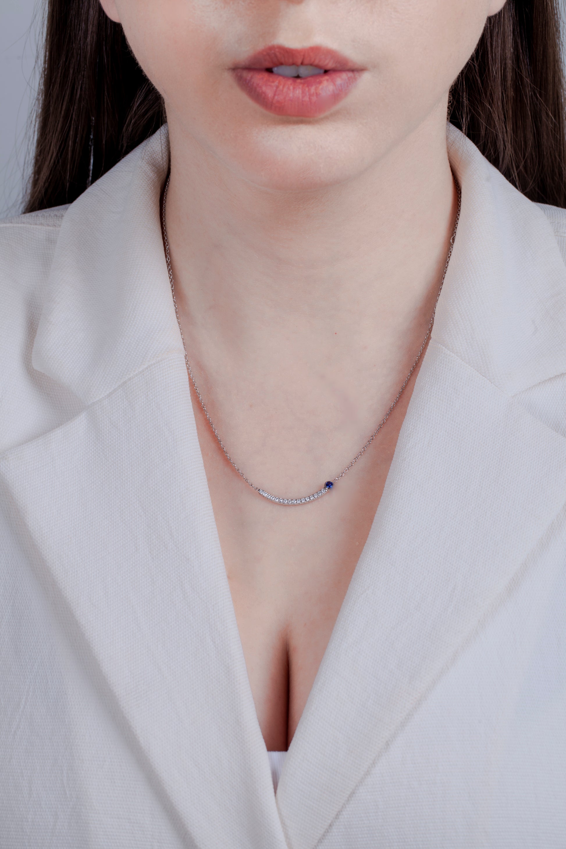 model wearing 925 Sterling Silver 1/4 Cttw White Diamond & Blue Sapphire Curved Bar Smile Necklace