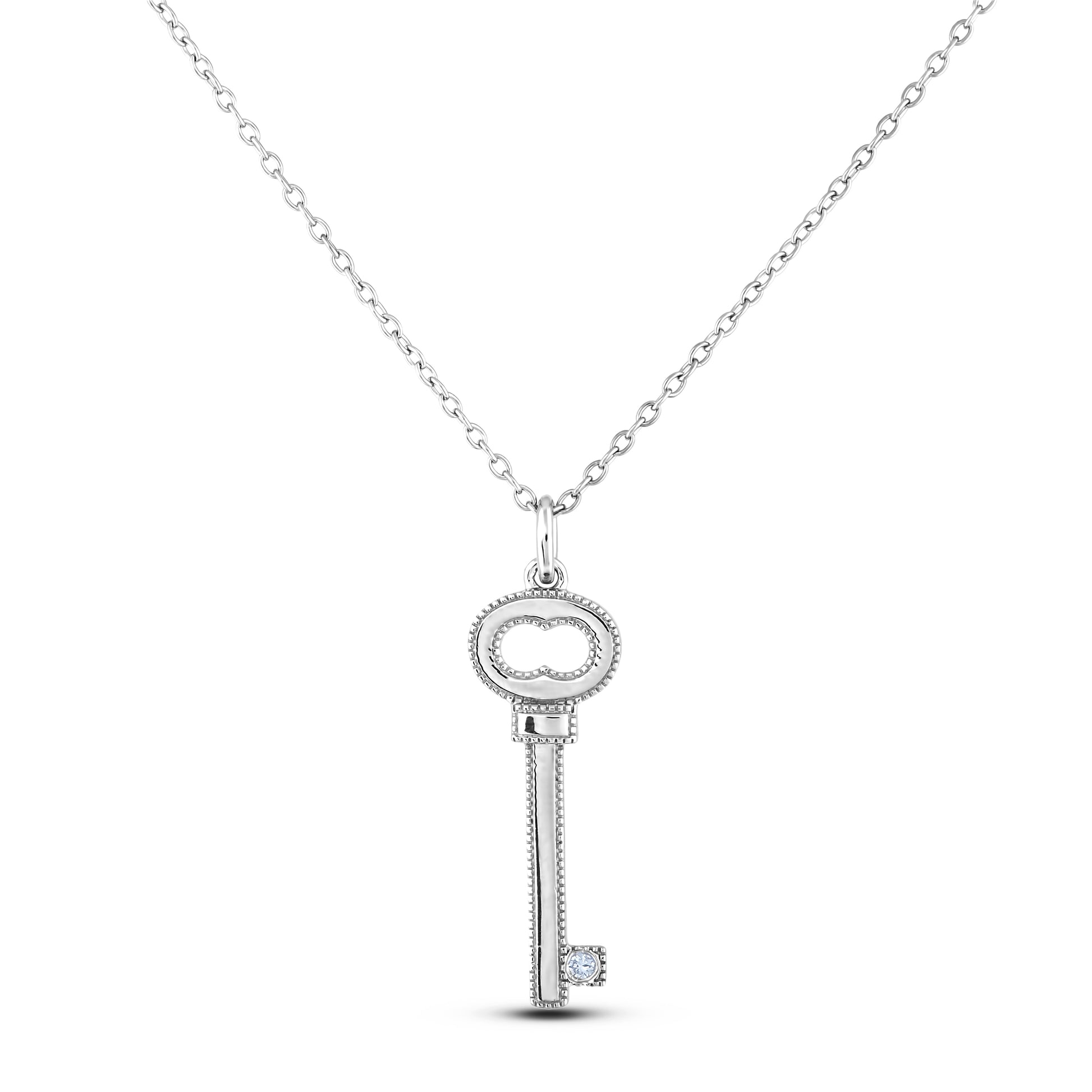 Sterling silver key pendant featuring a round brilliant cut, canadian diamond in the center. 