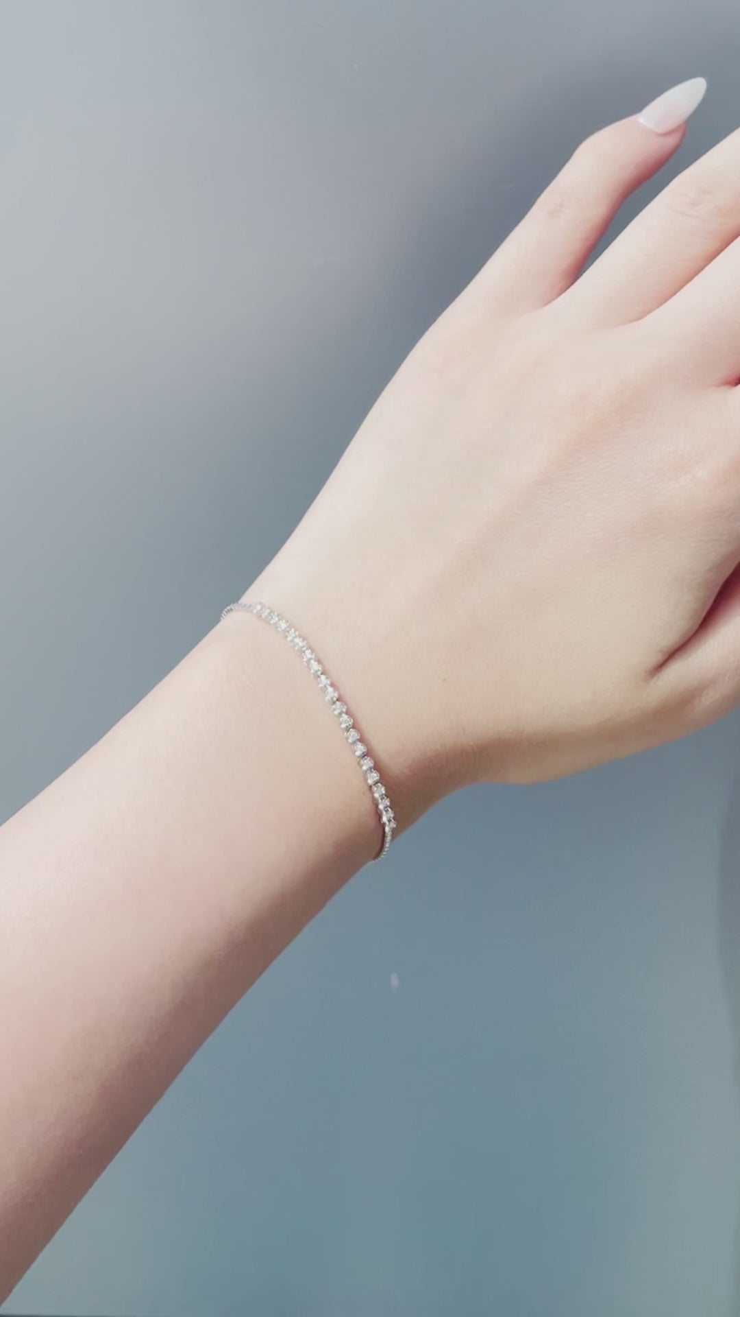 Video showing a sterling silver 0.20 Cttw Canadian diamond tennis bracelet in sunlight, featuring the sparkling diamonds and the star-detailed adjustable bolo chain and clasp.