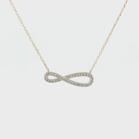 Rotating view of a 10K yellow gold infinity pendant necklace set with 0.18 carats of Canadian diamonds, showing the design from multiple angles.