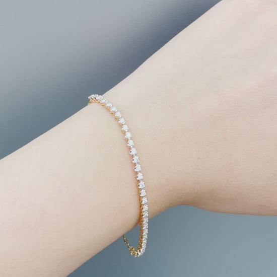 Watch a model wearing our 10K Yellow Gold 0.76 Cttw Canadian Diamond Half Tennis Bracelet with Chain. Highlights include close-up shots of the secure clasp mechanism, precision diamond setting, and natural sunlight showcasing the brilliant diamond sparkle.
