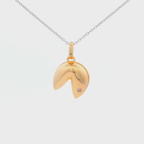 Gold plated sterling silver Fortune cookie charm with bezel set Canadian diamond hanging on a sterling silver rolo chain rotating, showing the design of the necklace and the brilliance of the diamond.