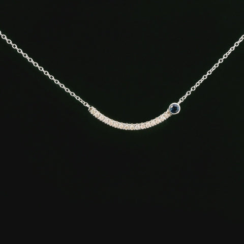 video of sapphire and diamond curved bar smile necklace rotating