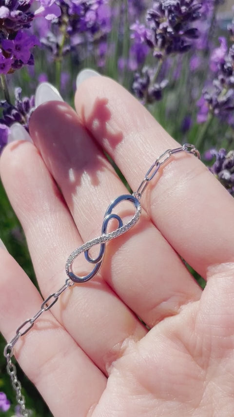 video close up of 925 Sterling Silver 0.15 Ctw Natural Canadian Diamond and Infinity Symbol Chain Paperclip Bracelet