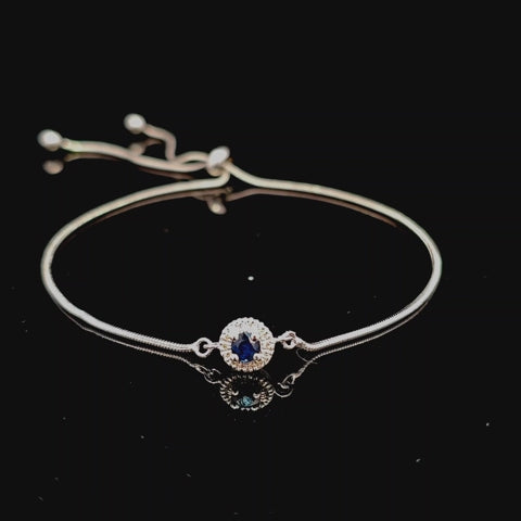 Rotating video of 925 sterling silver bolo bracelet with blue sapphire and canadian diamond halo