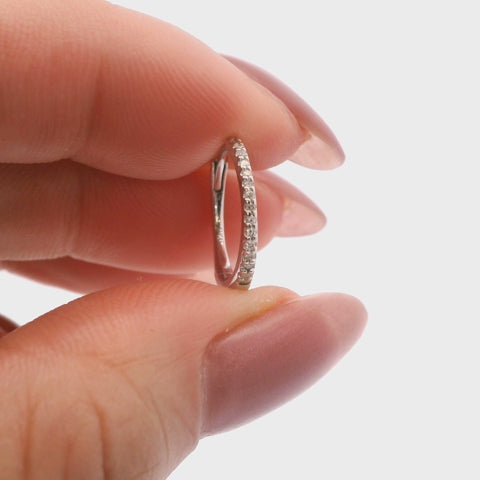 925 sterling silver Canadian diamond huggie earrings. Close-up video showcasing the sparkle of the round diamonds and the functional latch-back closure on a small silver hoop.