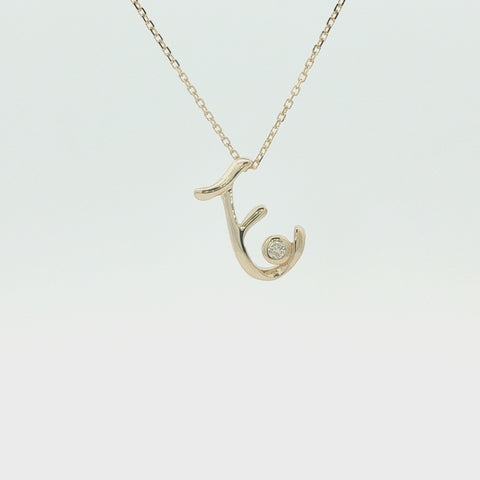 10K yellow gold letter E pendant close up, 360 degrees. 10K stamp on the back side of pendant.