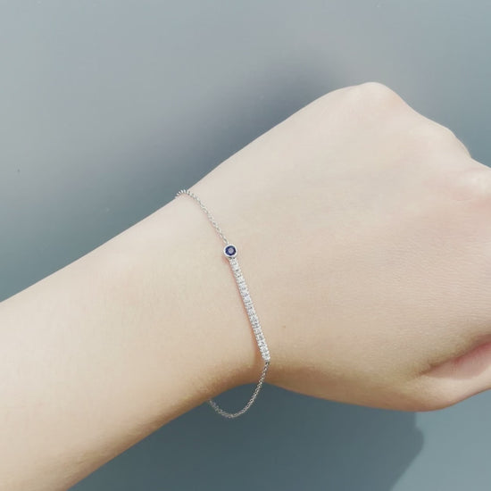 On-model video of the Sterling Silver Blue Sapphire and Canadian Diamond Line Bracelet in natural sunlight. Showcases the bezel-set sapphire, diamond line sparkle, and secure spring ring clasp.