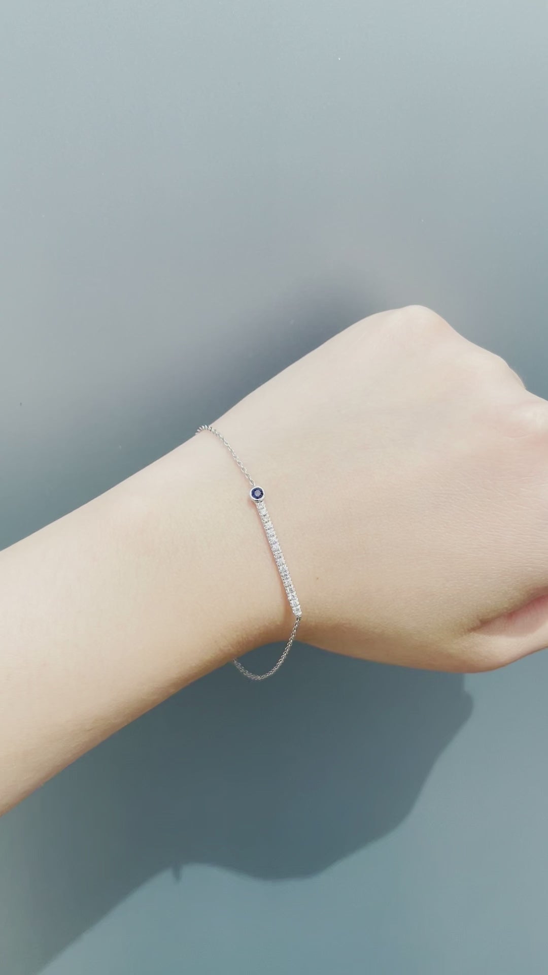 On-model video of the Sterling Silver Blue Sapphire and Canadian Diamond Line Bracelet in natural sunlight. Showcases the bezel-set sapphire, diamond line sparkle, and secure spring ring clasp.