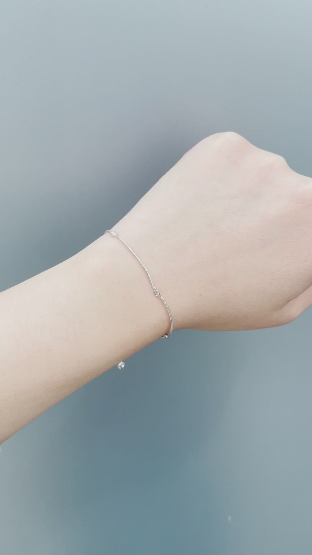 On-model showcase video of the Sterling Silver 0.06 Cttw Canadian Diamond Trilogy Adjustable Bolo Bracelet. Features close-up shots of the three natural Canadian diamonds (H-I color, SI2-I1 clarity) catching natural light, along with a view of the adjustable bolo slider mechanism.