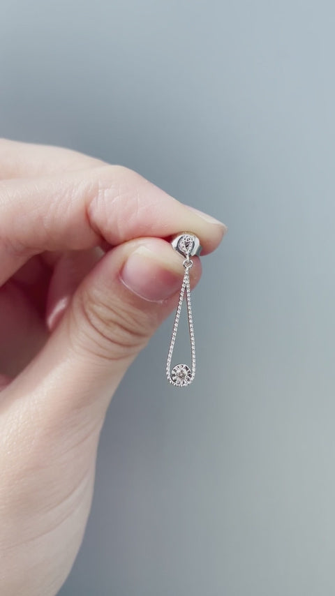 Product showcase video for the Sterling Silver 0.06 Cttw Canadian Diamond Droplet Dangle Stud Earrings. Includes close-up views highlighting the diamond droplet design (H-I color, SI2-I1 clarity), alongside an on-model video demonstrating ear placement, scale, and movement.