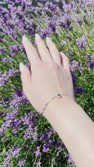 video of 925 Sterling Silver Sapphire and Canadian Diamond Halo Paperclip Bracelet under sunlight with lavender flowers