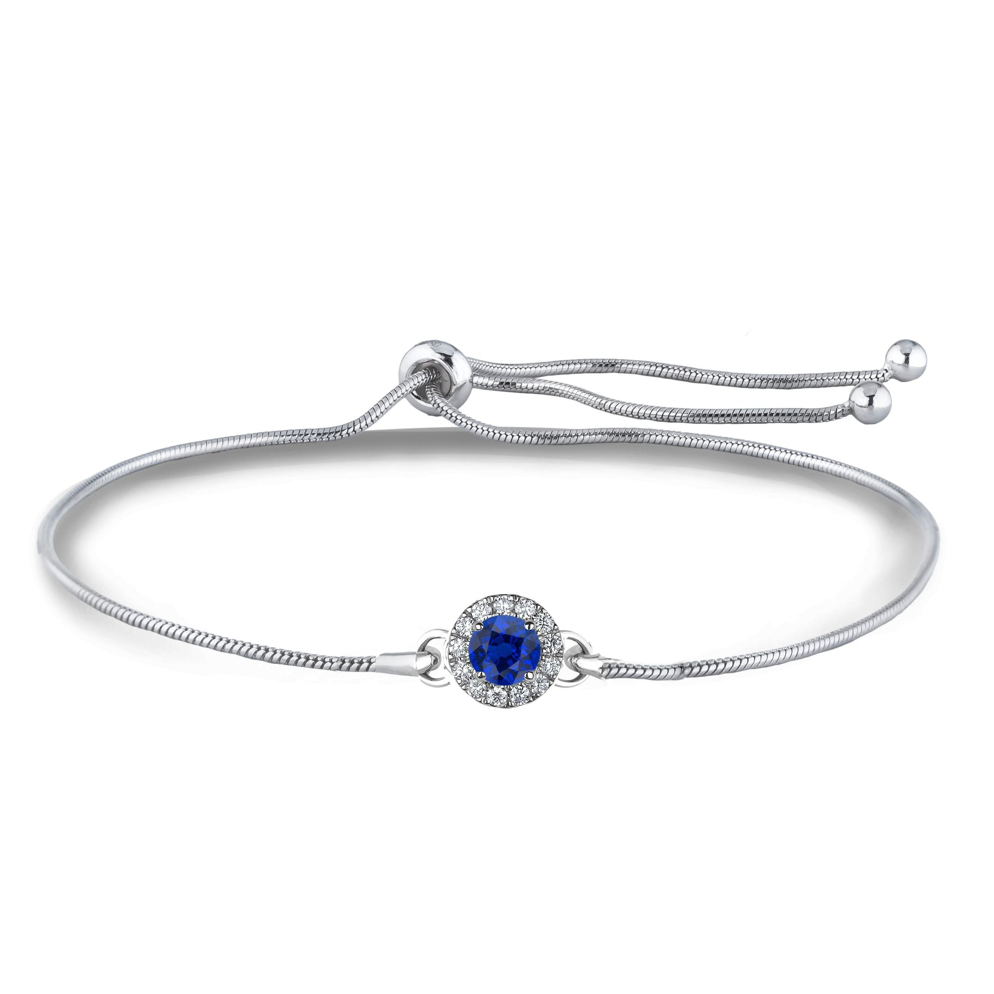 Close up of sterling silver bolo bracelet with a blue sapphire surrounded by Canadian diamonds in a halo setting on a white background