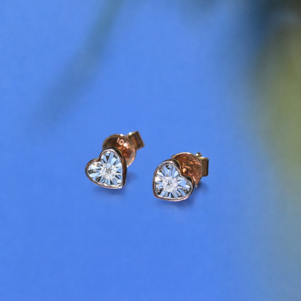 10k rose gold Heart-shaped diamond stud earrings on a sky blue background 